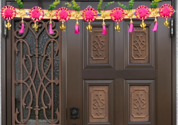 ethnic-pink-floral-door-toran-with-golden-bells-tassels-for-festive-decor.webp