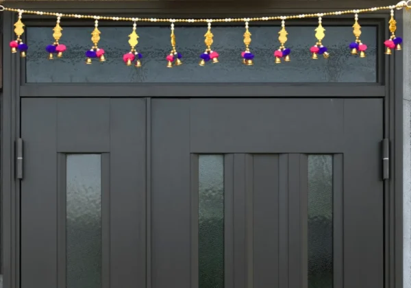 golden-door-toran-with-pom-poms-bells-for-festive-home-decor.webp