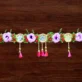 lotus-floral-toran-with-purple-roses-and-golden-tassels.webp