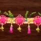 pink-floral-door-toran-with-golden-bells.webp